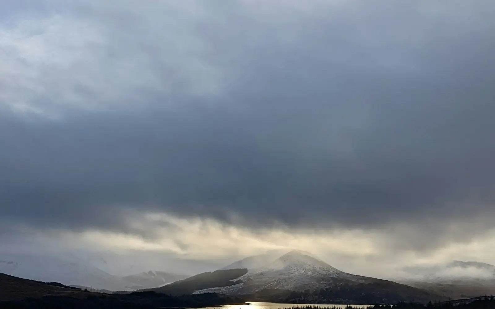 Snowy hills and winter light above Loch Tulla in the Scottish Highlands